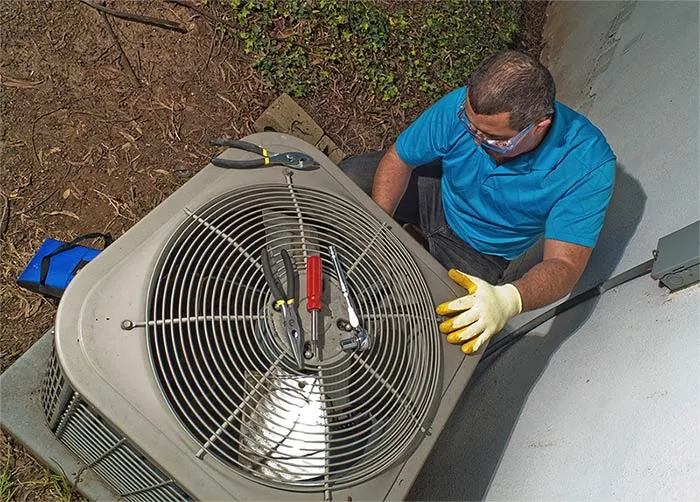 hvac technician performing a furnace model number lookup